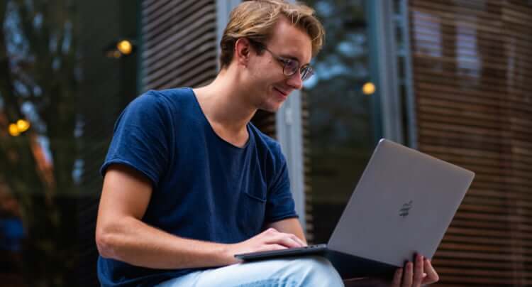 Image describing a guy using laptop